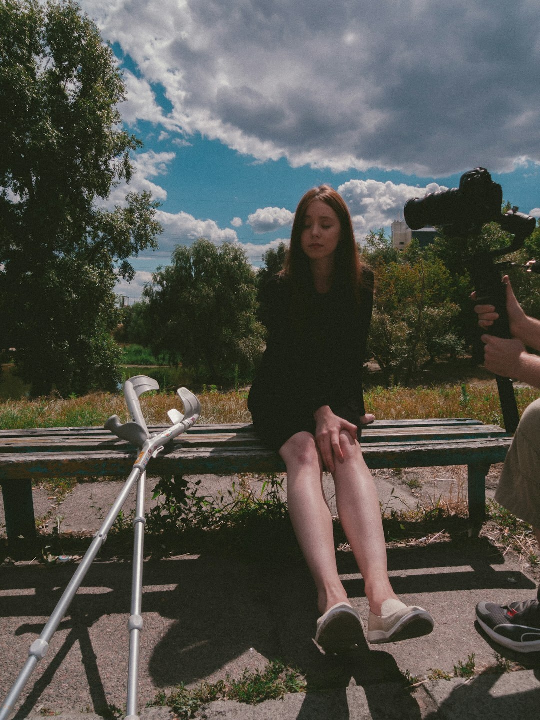 Journalist interviewing an elderly woman outdoors for a documentary