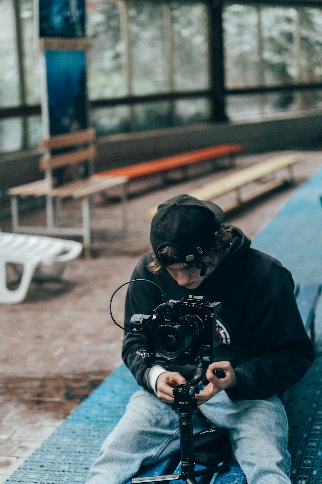 Camera operator filming an interview subject outdoors